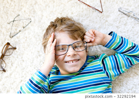 Close-up portrait of little blond kid boy with Close-up portrait of little blond kid boy with 32292194