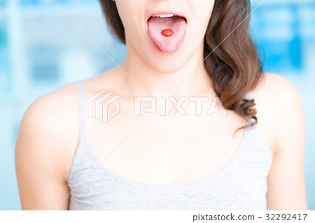 Young woman taking a tablet. The girl' 32292417