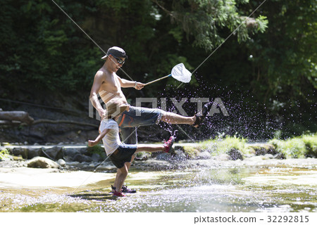 Parents and children playing in the river Parents and children playing in the river 32292815
