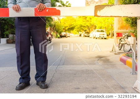 Security guard with barrier gate 32293194
