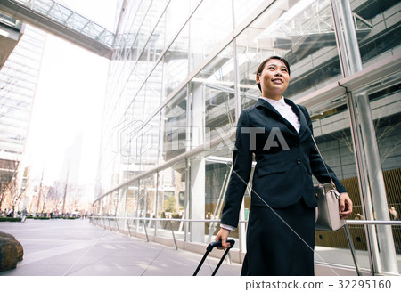 Businesswoman walking on a sidewalk 32295160