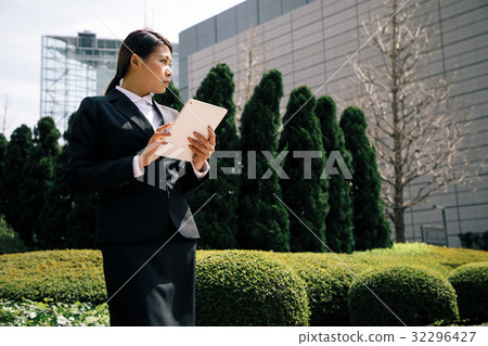 A woman using a tablet A woman using a tablet 32296427