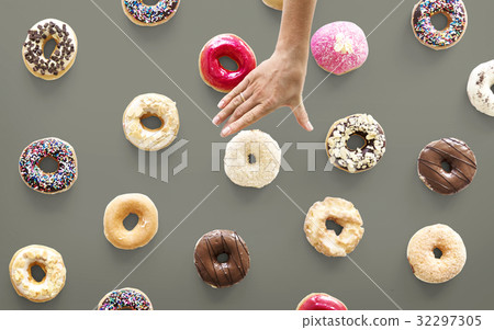 Hands selecting a variety of donut flavour Hands selecting a variety of donut flavour 32297305