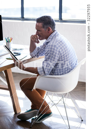 Profile view of a man using a digital tablet 32297935