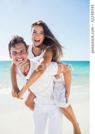 Portrait of handsome man holding his girlfriend Portrait of handsome man holding his girlfriend 32298595