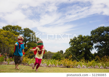 Children with superhero dress running and smiling 32298865