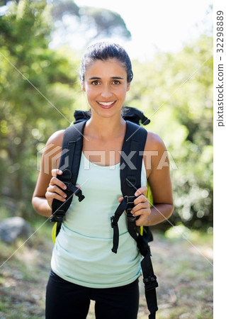 Woman smiling and posing with a backpack 32298889
