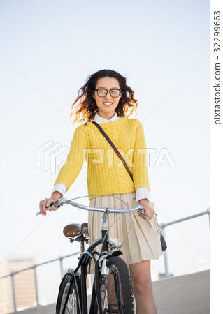 Hipster walking her bike 32299663
