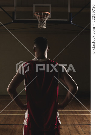 Basketball player with his hands on his hips Basketball player with his hands on his hips 32299756