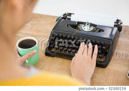 Hipster using type writer 32300159