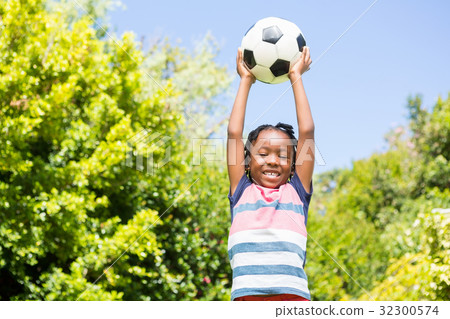 Smiling boy holding a ball Smiling boy holding a ball 32300574
