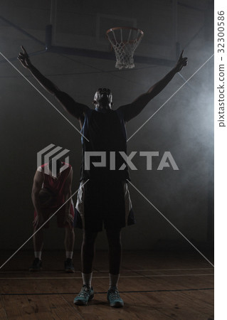 Victorious basketball player raising his arms up Victorious basketball player raising his arms up 32300586