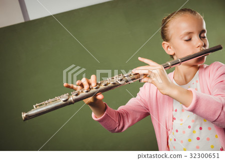 Girl playing the flute 32300651