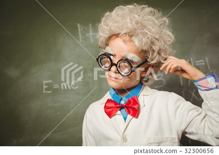 Boy standing in front of blackboard 32300656