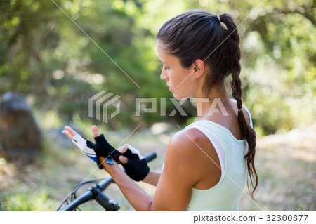 Concentrated woman preparing ride bike Concentrated woman preparing ride bike 32300877