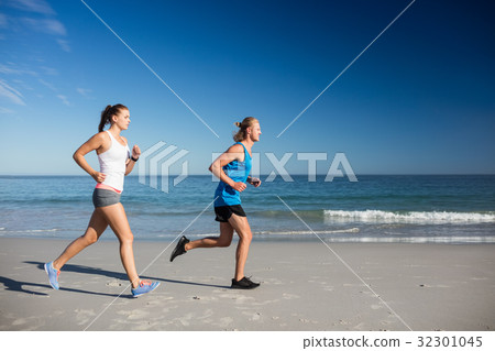 Friends jogging at the beach Friends jogging at the beach 32301045
