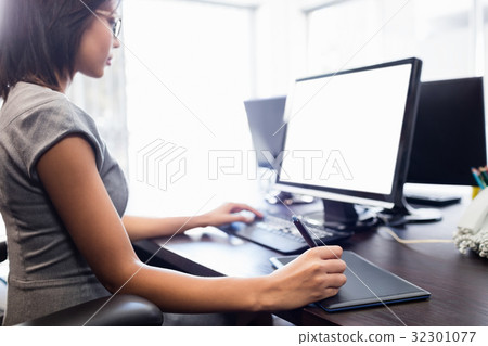 Casual businesswoman working on laptop Casual businesswoman working on laptop 32301077