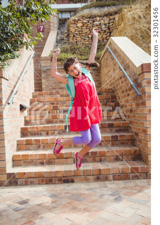 Cute little brunette child jumping 32301456