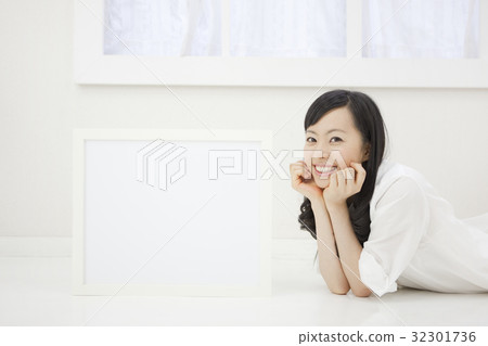 A lady lying down and a white board A lady lying down and a white board 32301736