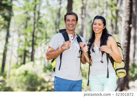 Couple smiling and posing with their backpack Couple smiling and posing with their backpack 32301872