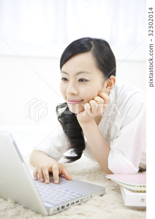 A woman watching a laptop A woman watching a laptop 32302014