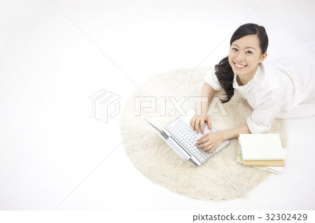 A woman watching a laptop A woman watching a laptop 32302429
