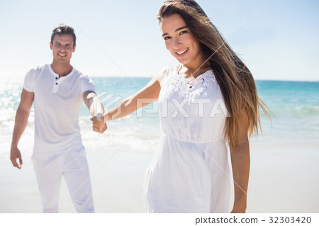 Pretty woman holding the hand of her boyfriend 32303420