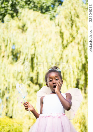 Cute mixed-race girl wearing a fairy dress 32304058