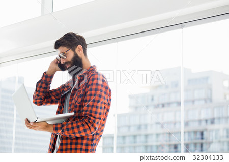 Hipster using phone and laptop 32304133