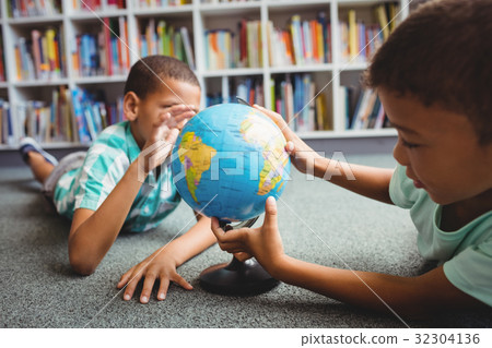 Boys studying the globe Boys studying the globe 32304136