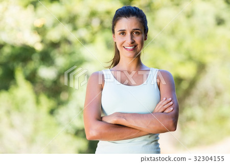 Woman smiling and crossing arms 32304155