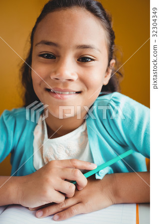 Girl sitting at a desk Girl sitting at a desk 32304349