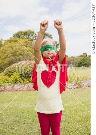 Portrait of young girl with superhero dress raising her arms 32304437