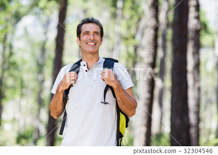 Man smiling and posing with his backpack Man smiling and posing with his backpack 32304546