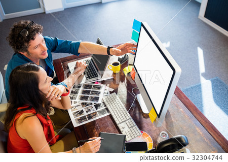 Colleagues using a graphic pad Colleagues using a graphic pad 32304744