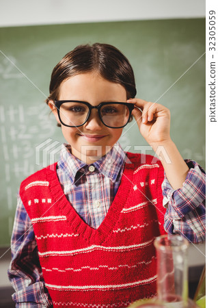 Boy touching his glasses Boy touching his glasses 32305059