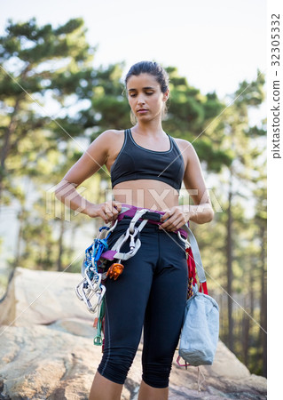 Woman standing with climbing equipment 32305332