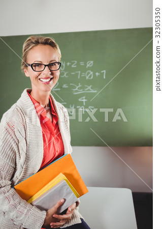 Teacher holding books Teacher holding books 32305350
