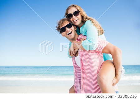 Happy couple posing on the beach 32306210