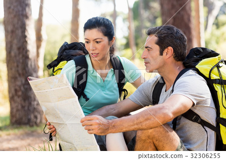 Couple sitting and studying a map 32306255