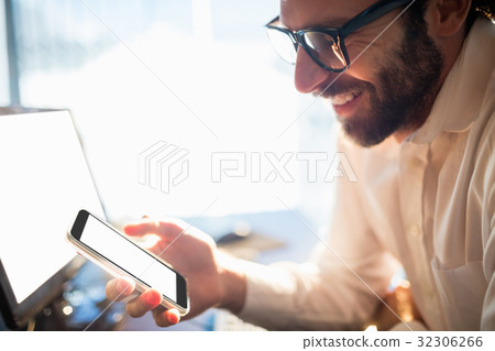 Businessman working and looking his phone Businessman working and looking his phone 32306266