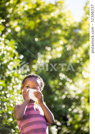 Boy is blowing his nose 32306337