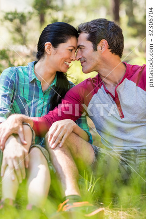 Couple sitting and holding each other Couple sitting and holding each other 32306704