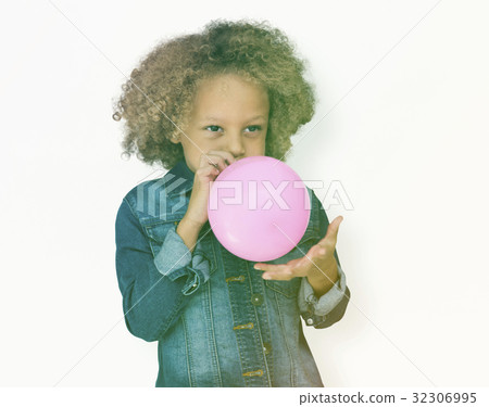 Young boy standing and blowing ab balloon Young boy standing and blowing ab balloon 32306995