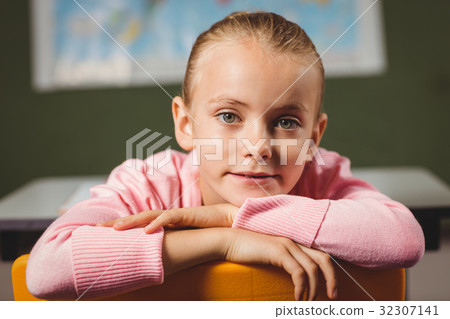 Girl leaning against chair Girl leaning against chair 32307141