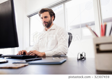 Businessman working on his computer Businessman working on his computer 32307459