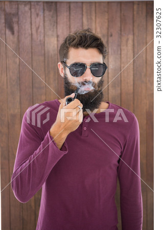 Hipster man smoking the pipe 32307625