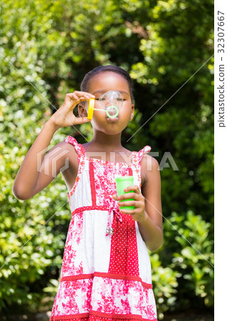Little girl is making bubble Little girl is making bubble 32307667