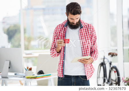 Hipster man looking on his notes Hipster man looking on his notes 32307670