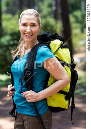 Woman smiling and posing with a backpack 32308409